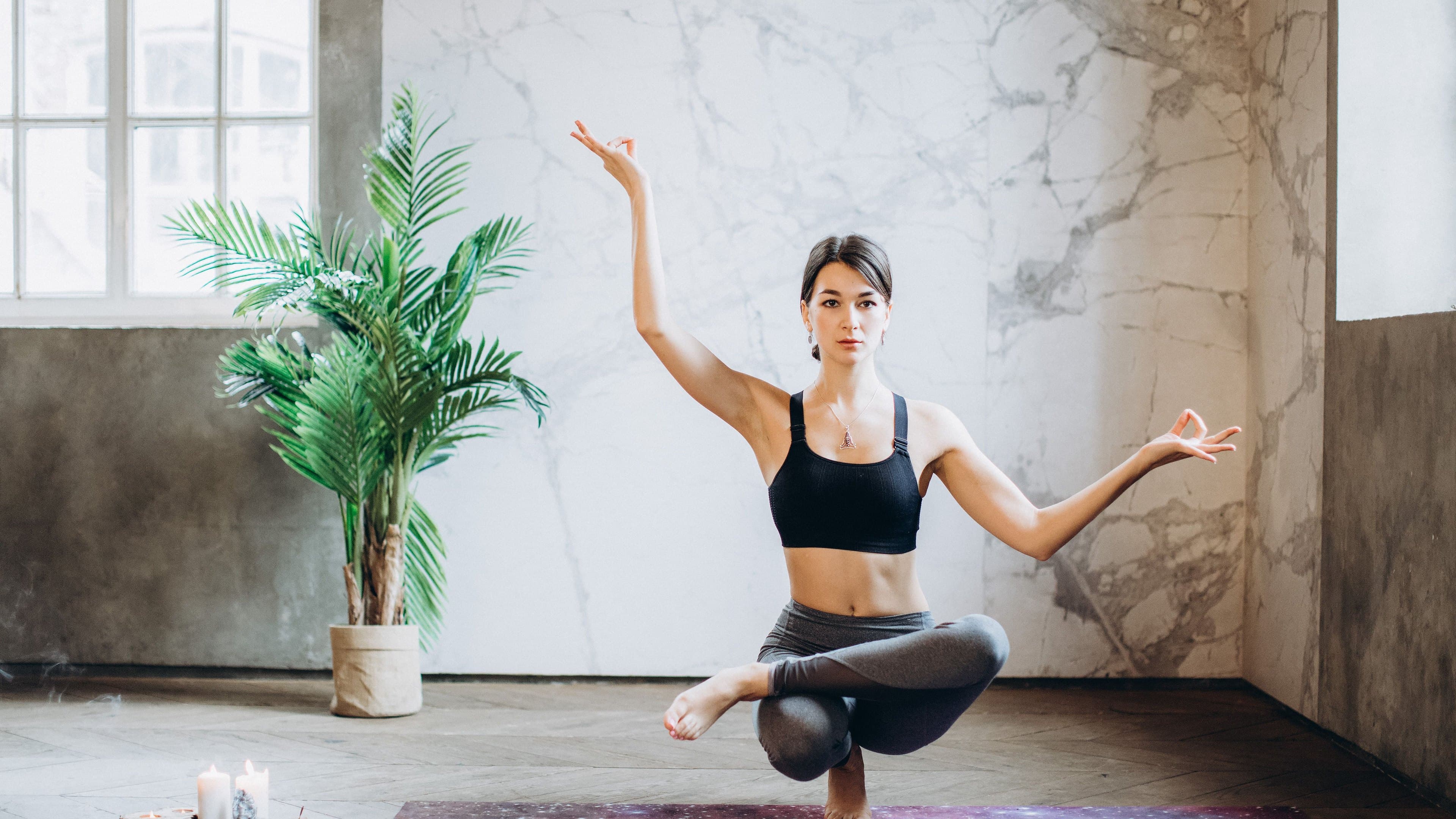 A woman balancing in a bright exercise studio