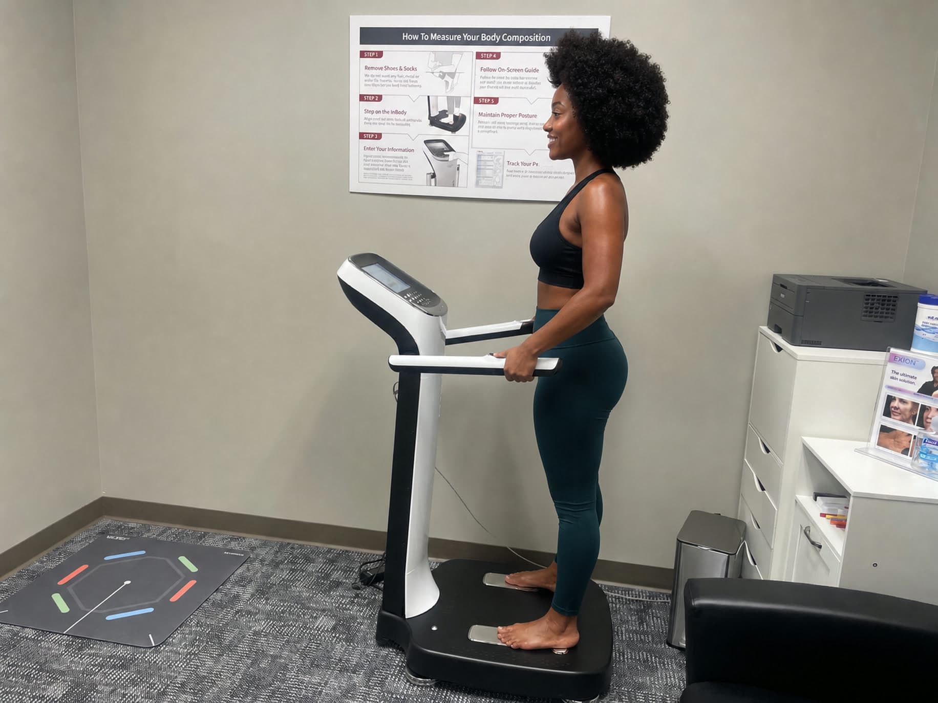 Black woman with a natural Afro standing on the InBody 970 at WellForm MD