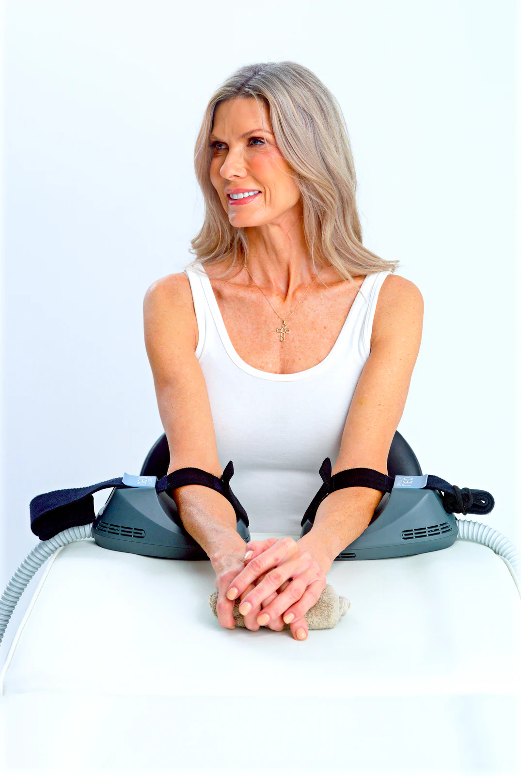 Small EMSCULPT NEO applicators secured to both upper arms